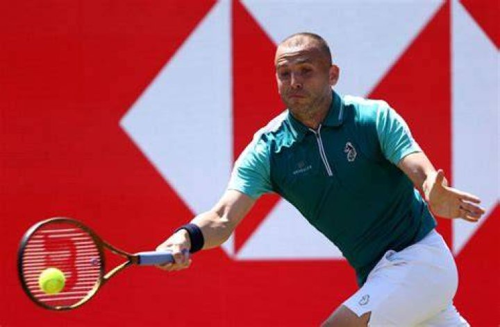 Dan Evans plays a shot